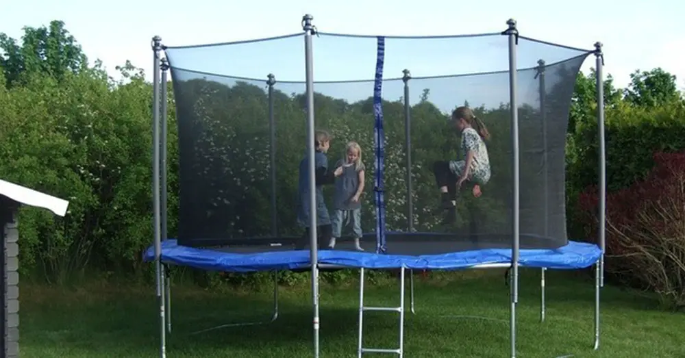 Kids Playing on a Trampoline in Spring