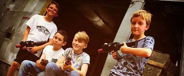 Group of kids with laser tag blasters