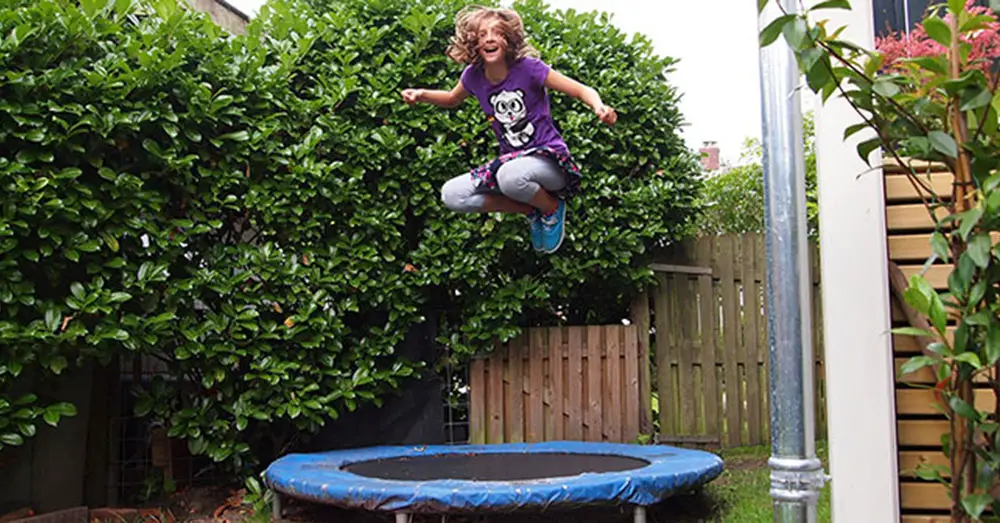 Young Girl Jumping on a Trampoline